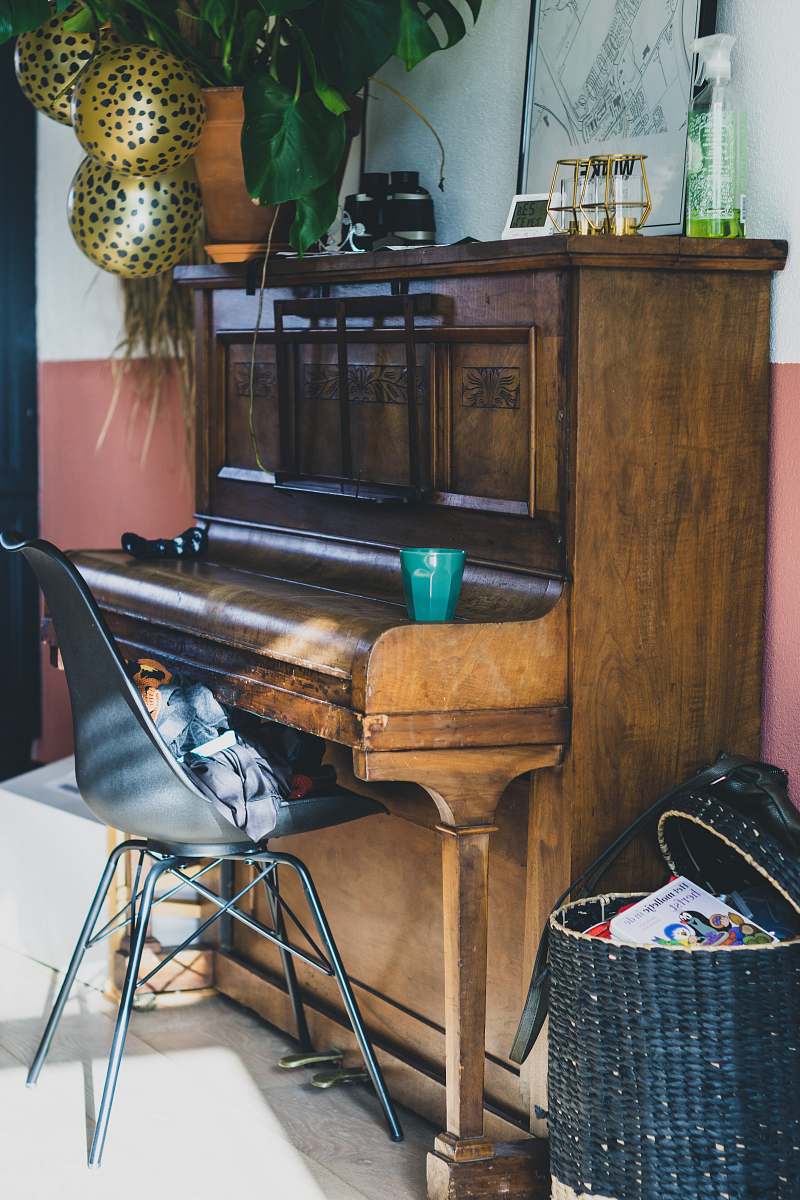 living room black wooden upright piano near brown wooden door furniture